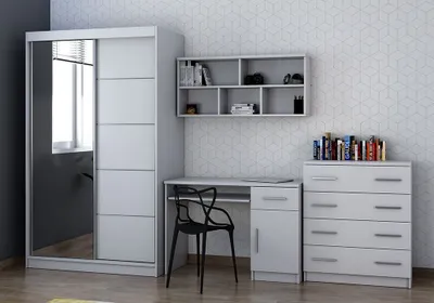 A bedroom set with a wardrobe, desk, chair, and chest of drawers against a patterned wall.