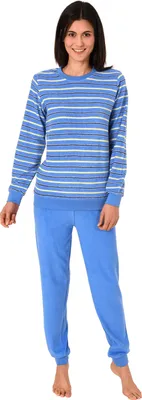 A woman is standing and modeling a blue and white striped pajama set.