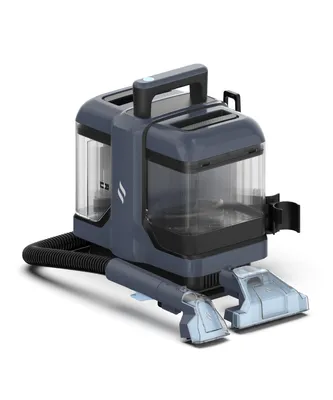 A dark gray and blue carpet cleaner with clear tanks and attachments, shown on a white background.