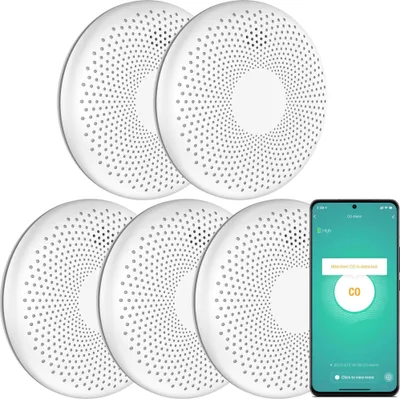 A set of five white smart smoke and carbon monoxide detectors are arranged in a cluster, with a smartphone displaying a connected app interface in the foreground.