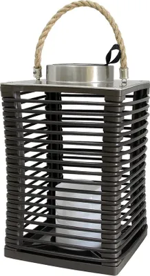 A solar lantern with a brown woven exterior and a white LED candle inside.