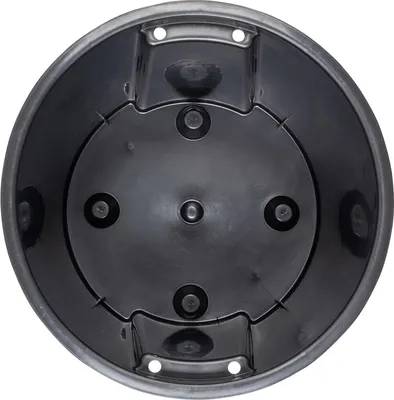 The underside of a black plastic plant pot insert.