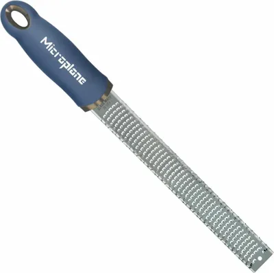 A close-up studio shot of a Microplane zester with a blue handle.