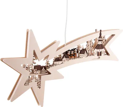 A wooden star-shaped ornament with a village scene carved into it, hanging from a white string.