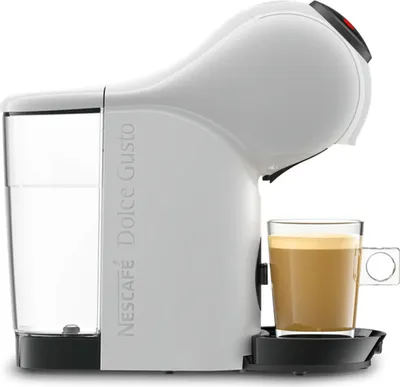 A white Nescafé Dolce Gusto coffee machine with a glass of coffee.