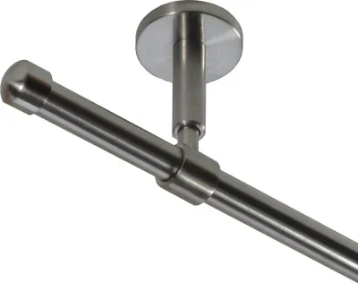 A close-up view of a metal curtain rod with a ceiling mount.