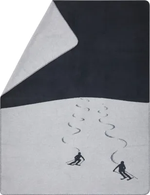 A blanket with a ski scene printed on it.