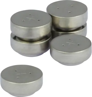 A group of silver coin-shaped batteries are stacked and arranged on a white background.