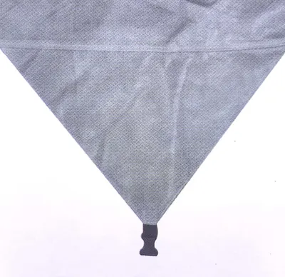 A close-up view of the bottom corner of a grey protective cover for a motorhome.