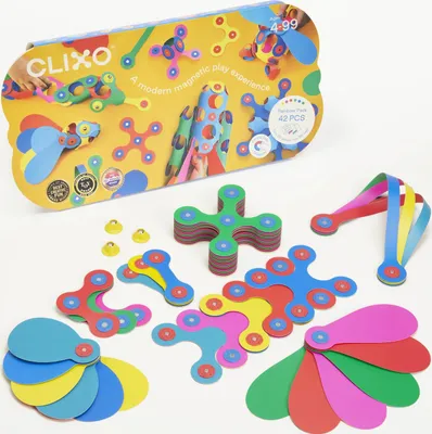 A collection of colorful magnetic building pieces and their packaging are displayed on a white surface.