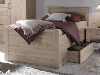 A bedroom setting with a bed and a nightstand.