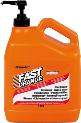 A large orange plastic bottle of hand cleaner with a pump dispenser.