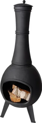 A black cast iron chiminea with wood inside, set against a white background.