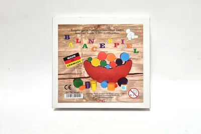 The image shows the packaging of a balance game with colorful pieces.