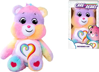 A rainbow-colored Care Bear plush toy is shown next to its packaging.