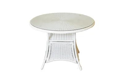 A white wicker table with a glass top is shown against a white background.