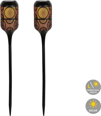 Two black solar-powered garden lights with a mosaic-like pattern on the top section, emitting a warm yellow and orange light.