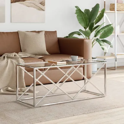 A living room scene with a couch, coffee table, and plant.