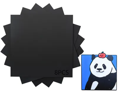 A stack of black square sheets and a separate image of a cartoon panda with an apple on its head.