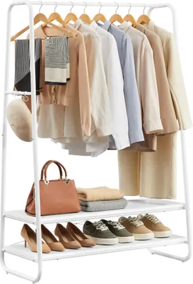 A white metal garment rack with clothes, scarves, a hat, a handbag, folded sweaters, and shoes on two shelves.