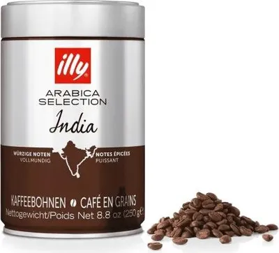 A can of illy Arabica Selection India coffee beans and a pile of coffee beans.