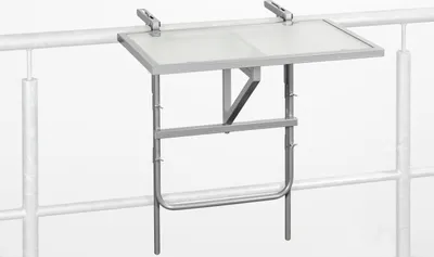A small silver metal balcony table with a frosted glass top, clamped to a railing.