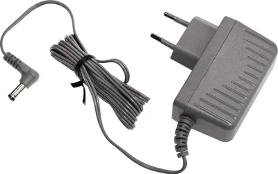 A gray power adapter with a European plug and a coiled cable with a connector.