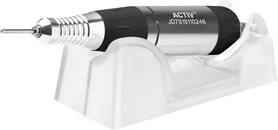 A nail drill is placed on a clear plastic stand against a white background.