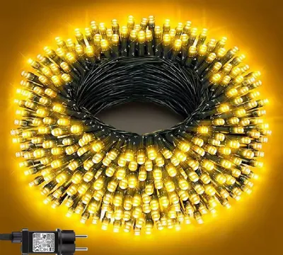 A coiled string of yellow LED lights with a power adapter.