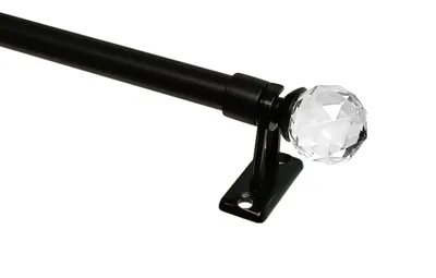 A close-up, studio shot of a curtain rod with a crystal finial.