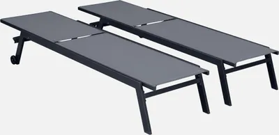 Two grey sun loungers are shown side-by-side against a white background.