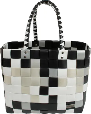 A black, white, and gray checkered woven basket bag with two handles.