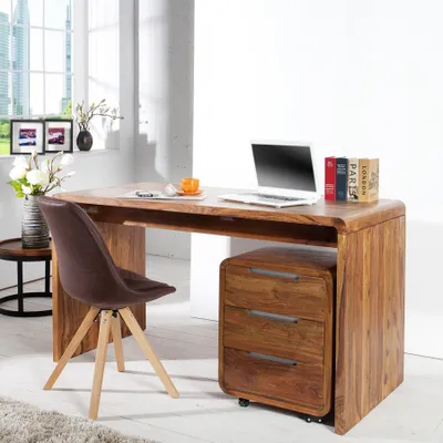 A modern home office setup with a wooden desk, laptop, and chair.