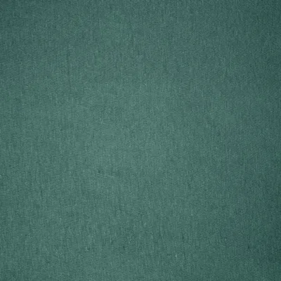 A close-up, full-frame shot of a teal-colored fabric.
