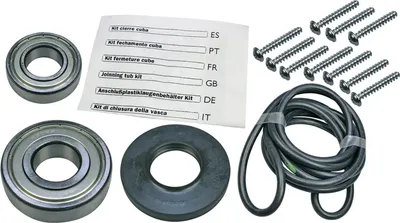 A collection of parts for a washing machine repair kit, including bearings, screws, a rubber seal, and an instruction sheet.
