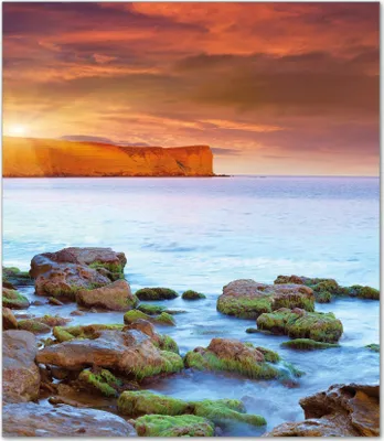 Produktbild von Wallario Herdabdeckplatte aus Glas, Größe 52 x 60 cm 1-teilig, Motiv Sonnenaufgang am Meer mit Landzunge und Felsen im Wasser