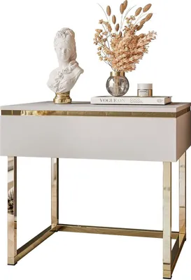 A white nightstand with gold accents, featuring a bust, a vase with dried flowers, and a jar on top.