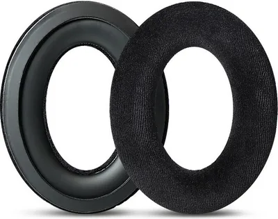 Two black headphone ear pads are shown on a white background. One is a ring with a leather-like outer surface and a foam inner cushion. The other is a plush fabric ring.