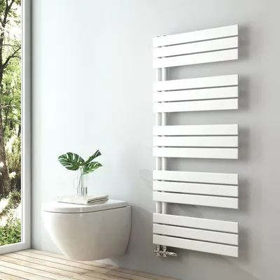 A modern bathroom setting with a wall-mounted toilet and a white designer towel radiator.
