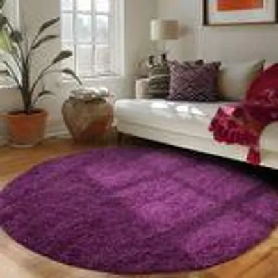 A living room scene with a purple rug in the foreground and a sofa in the background.