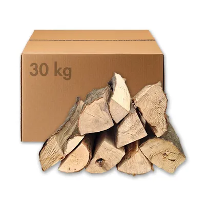 A cardboard box with '30 kg' printed on it, and a pile of firewood in front of it.