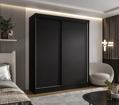 A modern bedroom with a large black sliding door wardrobe.