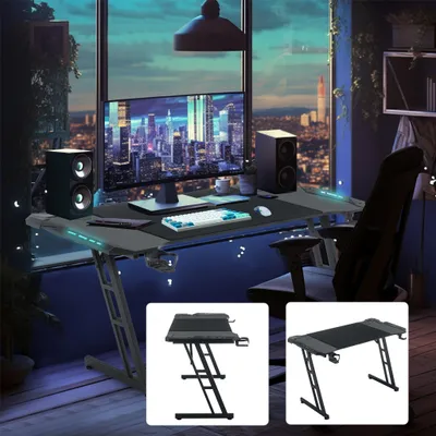 Produktbild von UISEBRT Gaming Tisch 140 x 60cm LED Gaming Schreibtisch Stabiler Computertisch PC Tisch Schwarz mit Getränkehalter & Kohlefaserbeschichtung 2 Öffnungen für Kabel Gamer Tisch Gaming Bürotisch-mit LED