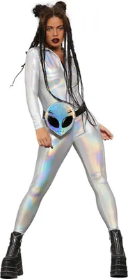 A woman wearing a silver holographic catsuit and black platform boots, posing against a white background.