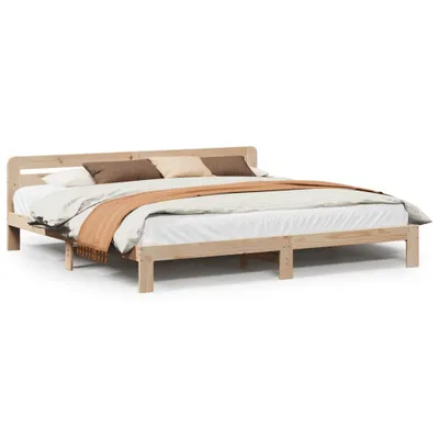 A wooden bed frame with bedding and pillows, shown against a white background.
