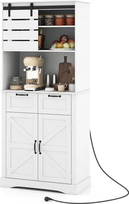 A white kitchen cabinet with sliding barn doors on top, a coffee maker, and jars on shelves. The cabinet has two drawers and two doors at the bottom, with a black power cord extending from the right side.