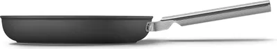A side view of a black frying pan with a silver handle against a white background.