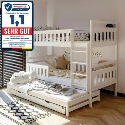 A white wooden bunk bed with a pull-out trundle bed in a bedroom setting.