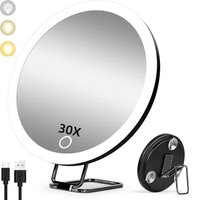 A makeup mirror with LED lights and a stand, shown with charging cables and a smaller detachable mirror.