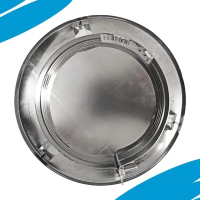 A close-up of a circular metal object with ridges and clips on its inner rim.